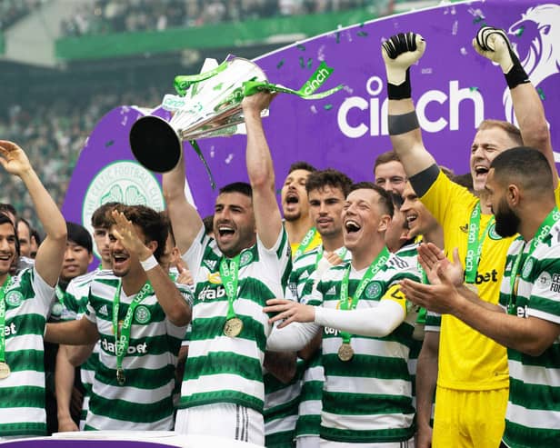 Celtic's Greg Taylor lifts the Premiership trophy after the 5-0 win over Aberdeen. (Photo by Craig Williamson / SNS Group)