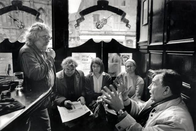 The poets' "kitchen cabinet" enjoys a friendly discussion in Sandy Bell's pub in Forrest Road, Edinburgh in November 1994.