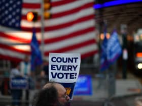 A protester holds a placard that reads "Count Every Vote" while demonstrating across the street from supporters of Donald Trump outside an election count in Philadelphia, Pennsylvania (Picture: Mark Makela/Getty Images)