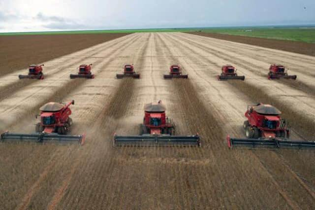 Combine harvesters crop soybeans on what was once rainforest in Brazil (Picture: Yasuyoshi Chiba)