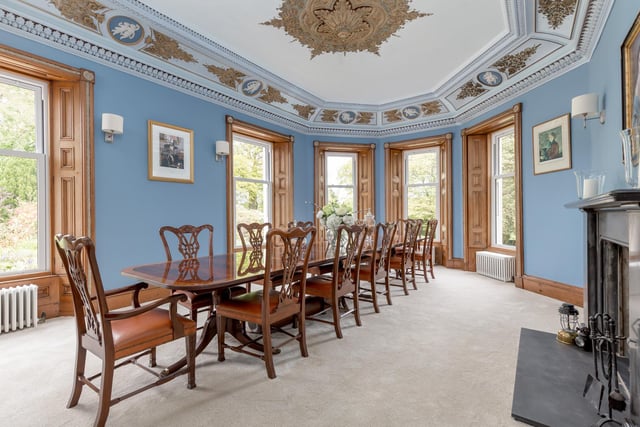 It features a grand open fireplace and detailed ceiling plasterwork