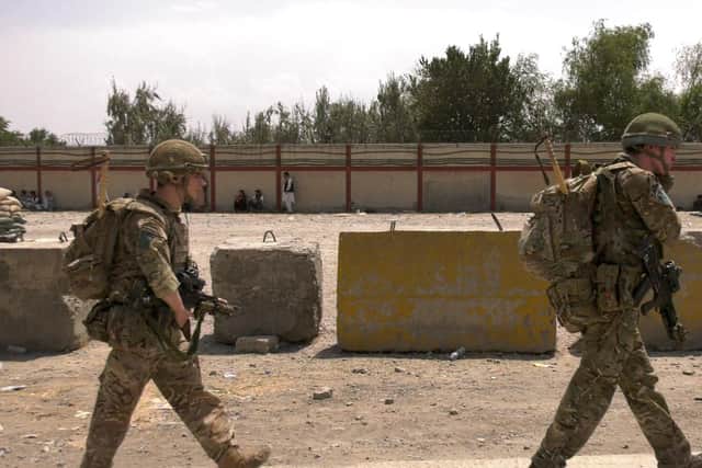 A handout picture released by the British Ministry of Defence (MOD) shows British soldiers working at Kabul Airport on August 22