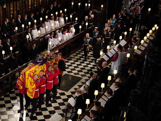 The coffin of Queen Elizabeth II, followed by (left to right, from front) King Charles III, the Queen Consort, the Princess Royal, Vice Admiral Sir Tim Laurence, the Duke of York, the Earl of Wessex, the Countess of Wessex, the Prince of Wales, Prince George, Princess Charlotte, the Princess of Wales, the Duke of Sussex, the Duchess of Sussex, Peter Phillips, the Earl of Snowdon, the Duke of Gloucester, the Duke of Kent, and Prince Michael of Kent, is carried by the Bearer Party in to the Committal Service at St George's Chapel in Windsor Castle, Berkshire.