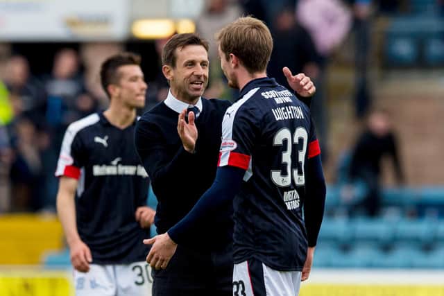 Neil McCann (left) celebrates with Craig Wighton at full time after a 1-1 draw with Ross County secured Dundee's Premiership safety in May 2017