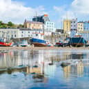 Boats in Tenby bay at low tide with the town above. Pic: Tamas Gabor