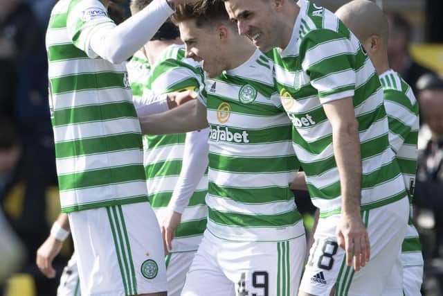 Celtic's James Forrest (centre) is congratulated by his team-mates after his Livingston goal that places him in an exclusive club of 10 players to have netted in 13 consecutive top flight season in the near-50 year Premier era. (Photo by Paul Devlin / SNS Group)