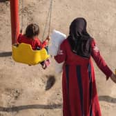 A mother spends time with her children in a park provided by an aid organisation in earthquake-hit Syria.