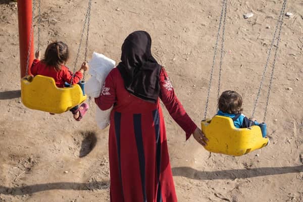 A mother spends time with her children in a park provided by an aid organisation in earthquake-hit Syria.