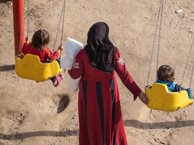 A mother spends time with her children in a park provided by an aid organisation in earthquake-hit Syria.