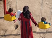 A mother spends time with her children in a park provided by an aid organisation in earthquake-hit Syria.