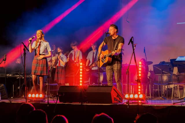 Support: Ups and Downs patron Callum Beattie on stage at Hamilton College's 40th anniversary concert.