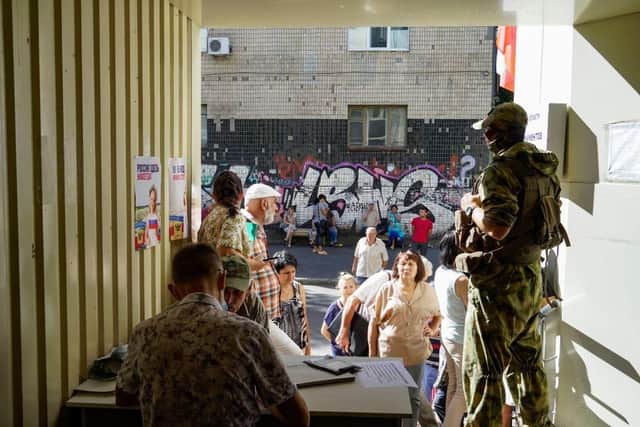 Residents apply for Russian citizenship in Kherson on July 21, 2022, amid the ongoing Russian military action in Ukraine. (Photo by STRINGER / AFP) (Photo by STRINGER/AFP via Getty Images)