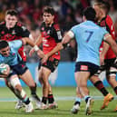 Mosese Tuipulotu, with ball in hand, in action for New South Wales Waratahs against Crusaders. (Photo by Sanka Vidanagama / AFP)