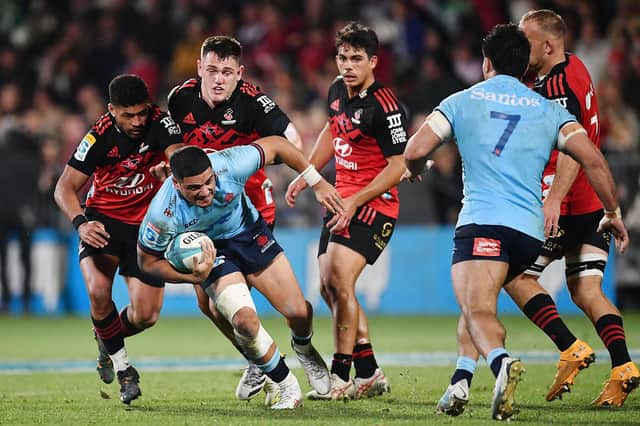 Mosese Tuipulotu, with ball in hand, in action for New South Wales Waratahs against Crusaders. (Photo by Sanka Vidanagama / AFP)