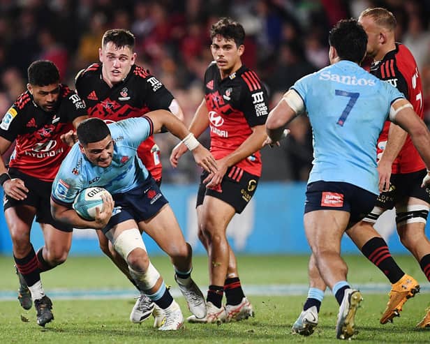 Mosese Tuipulotu, with ball in hand, in action for New South Wales Waratahs against Crusaders. (Photo by Sanka Vidanagama / AFP)