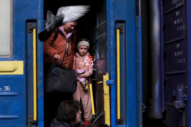 People arrive at the main train station from the area of Dnipro in Lviv, Ukraine. Photo by Joe Raedle/Getty
