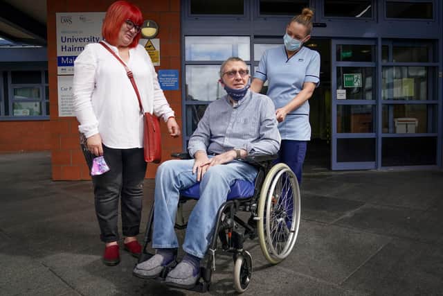 Neil McLaughlin, with partner Wendy Busby (left), leaves the University Hospital Hairmyres, East Kilbride, after being discharged.