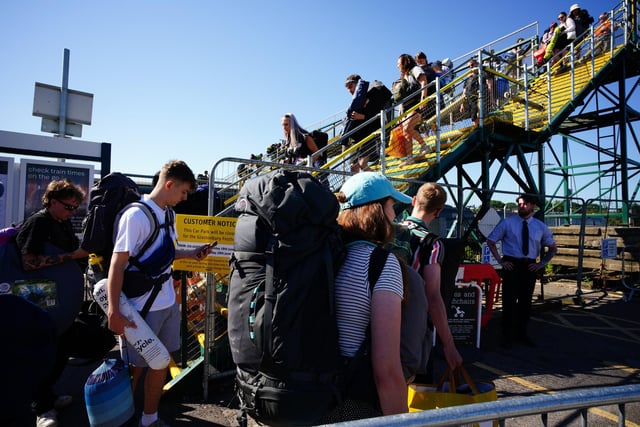 People arrive at Castle Cary train station during the Glastonbury Festival at Worthy Farm in Somerset. The festival is celebrating its 50th anniversary, with thousands flocking to Worthy Farm in Pilton, Somerset for the five-day event.