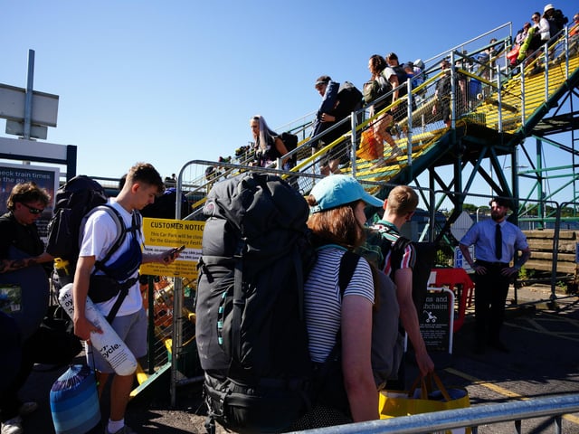People arrive at Castle Cary train station during the Glastonbury Festival at Worthy Farm in Somerset. The festival is celebrating its 50th anniversary, with thousands flocking to Worthy Farm in Pilton, Somerset for the five-day event.