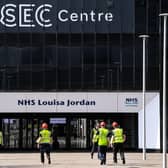A picture shows contractors on the site outside the new NHS Louisa Jordan hospital at the Scottish Events Campus (SEC) in Glasgow. (Photo by ANDY BUCHANAN/AFP via Getty Images)