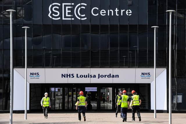 A picture shows contractors on the site outside the new NHS Louisa Jordan hospital at the Scottish Events Campus (SEC) in Glasgow. (Photo by ANDY BUCHANAN/AFP via Getty Images)