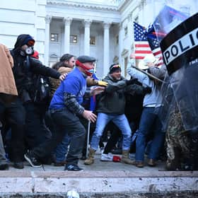 Trump supporters clash with police and security forces, as they storm the US Capitol in Washington, DC, on January 6, 2021. - Demonstrators breeched security and entered the Capitol as Congress debated the a 2020 presidential election Electoral Vote Certification. (Photo by Brendan SMIALOWSKI / AFP) (Photo by BRENDAN SMIALOWSKI/AFP via Getty Images)