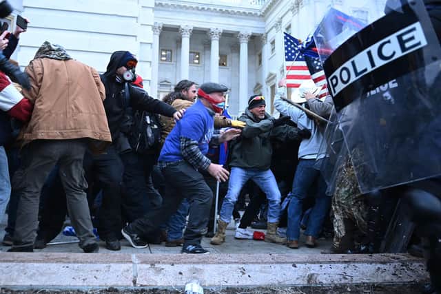 Trump supporters clash with police and security forces, as they storm the US Capitol in Washington, DC, on January 6, 2021. - Demonstrators breeched security and entered the Capitol as Congress debated the a 2020 presidential election Electoral Vote Certification. (Photo by Brendan SMIALOWSKI / AFP) (Photo by BRENDAN SMIALOWSKI/AFP via Getty Images)