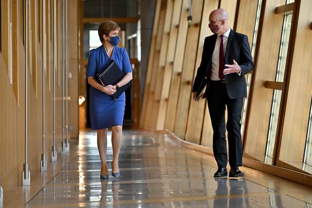 First Minister Nicola Sturgeon and deputy John Swinney walk up a corridor prior to updating MSPs in any changes to coronavirus restrictions. Picture: Jeff J Mitchell-Pool/Getty Images