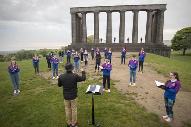 The National Youth Choir of Scotland, with founder and conductor Christopher Bell, meet on Edinburgh's Calton Hill to sing together for the first time since March 2020 (Picture: Jane Barlow/PA Wire)