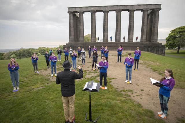 The National Youth Choir of Scotland, with founder and conductor Christopher Bell, meet on Edinburgh's Calton Hill to sing together for the first time since March 2020 (Picture: Jane Barlow/PA Wire)