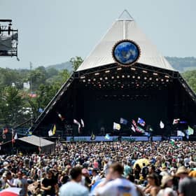 Crowds of festival-goers watch Tom Odell perform on the Pyramid Stage during day three of Glastonbury Festival in 2019.