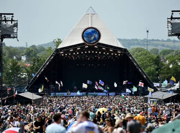 Crowds of festival-goers watch Tom Odell perform on the Pyramid Stage during day three of Glastonbury Festival in 2019.