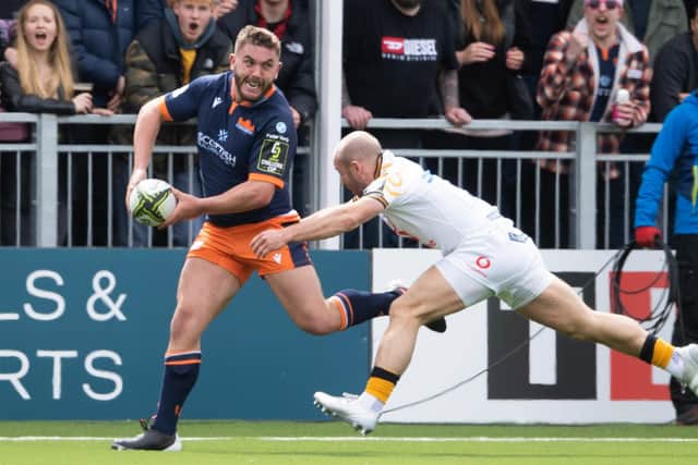Edinburgh's Adam McBurney is tackled by Wasps' Dan Robson during the Challenge Cup quarter-final at DAM Health Stadium. (Photo by Ross Parker / SNS Group)