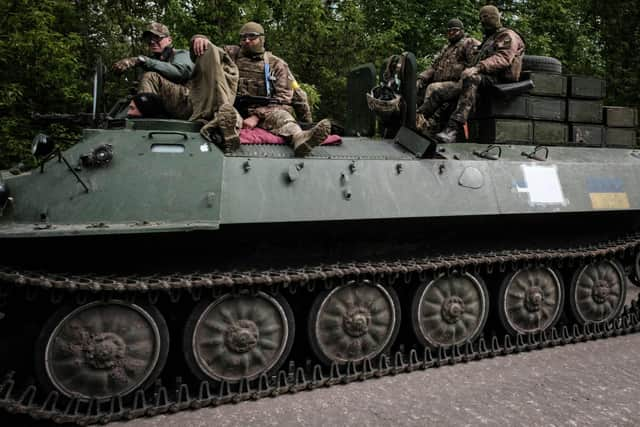 Ukrainian soldiers ride on a light armored multi-purpose towing vehicle near Bakhmut, eastern Ukraine, on May 15, 2022, amid the Russian invasion of Ukraine. (Photo by Yasuyoshi Chiba via Getty Images)