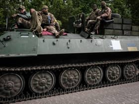 Ukrainian soldiers ride on a light armored multi-purpose towing vehicle near Bakhmut, eastern Ukraine, on May 15, 2022, amid the Russian invasion of Ukraine. (Photo by Yasuyoshi Chiba via Getty Images)