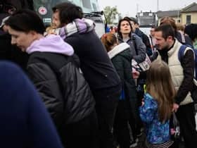 Refugees from the war torn regions of Ukraine board a coach to Poland at a coach station.
