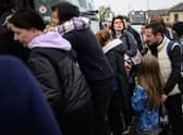 Refugees from the war torn regions of Ukraine board a coach to Poland at a coach station.