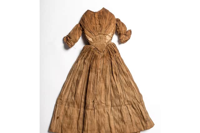 The doll's original dress stained with peat smoke. PIC: Jim Dunn.