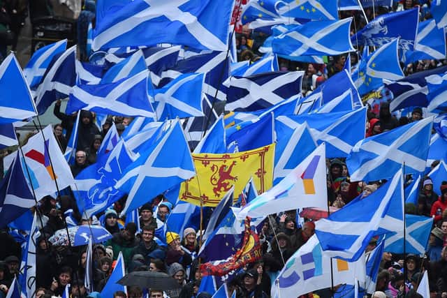 Protesters with Scottish Saltire flags attend a march organised by the grassroots organistaion All Under One Banner calling for Scottish independence in Glasgow. Picture: Andy Buchanan/AFP via Getty Images