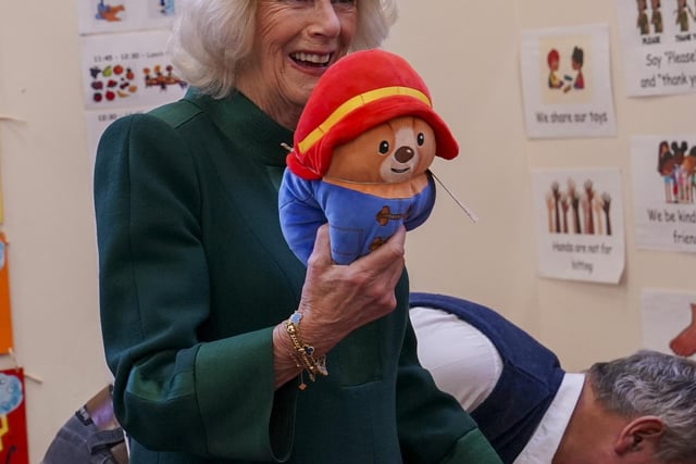 Camilla gently told the children to place the tiny boots on their Paddington bears “otherwise he won’t be able to go outside”.