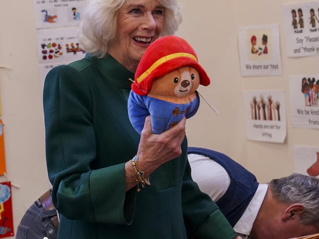 Camilla gently told the children to place the tiny boots on their Paddington bears “otherwise he won’t be able to go outside”.