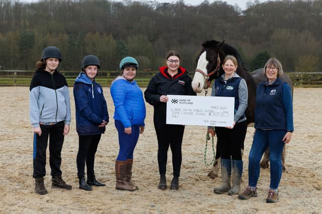 Alice Henderson from Harbro hands over a cheque to Amanda Namey, Service  Manager at Equi-Power Central Scotland RDA. (Pic: Mark Ferguson).