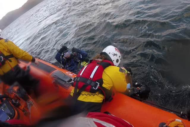 Divers being helped from the water. Picture: RNLI