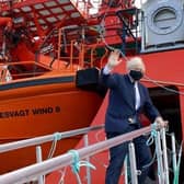 Boris Johnson boards the vessel Alba in Fraserburgh Harbour on his way to the Moray Offshore Windfarm East during his visit to Scotland