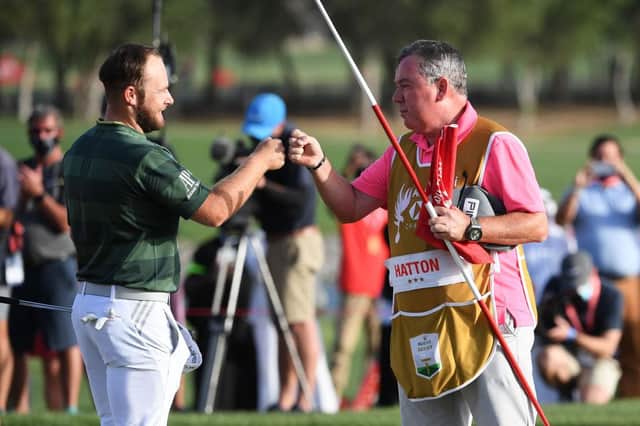 Tyrrell Hatton fist bumps Scottish caddie Mick Donaghy following his victory in the Abu Dhabi HSBC Championship at Abu Dhabi Golf Club. Picture: Ross Kinnaird/Getty Images.