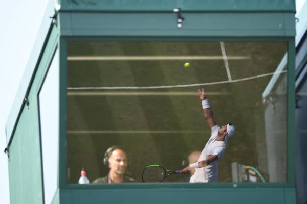 Russia's Karen Khachanov is reflected in a commentary box at Wimbledon. (Photo: OLI SCARFF/AFP via Getty Images)
