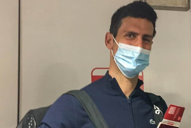 Novak Djokovic disembarks from a plane at the airport in Dubai on January 17, 2022, after losing a legal battle in Australia on January 16 over his coronavirus vaccination status.