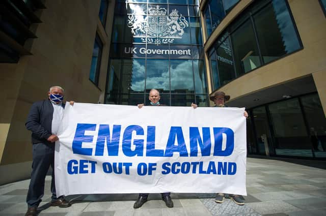 James Connolly, Sean Clerkin and John Lowe, protested at Queen Elizabeth House in Edinburgh to demand that the border with England be closed immediately. Picture: Colin D Fisher / SWNS.COM