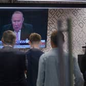 Staff in the green room watching a television screen showing presenter Andrew Neil broadcast from a studio, during the launch event for new TV channel GB News.