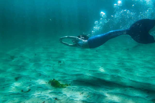 Kate Macleod pictured underwater wearing her custom-made fin tale, which she was sent from Hawaii. PIC: BBC ALBA.